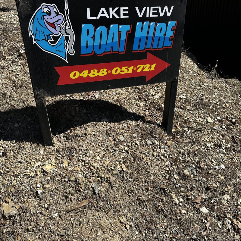 Sign reads 'Lake View Boat Hire' with a cartoon fish and phone number.